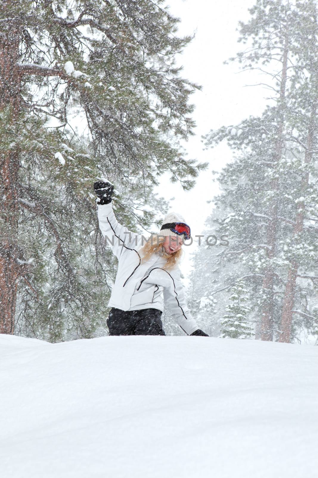 Portrait of young beautiful woman on winter outdoor background