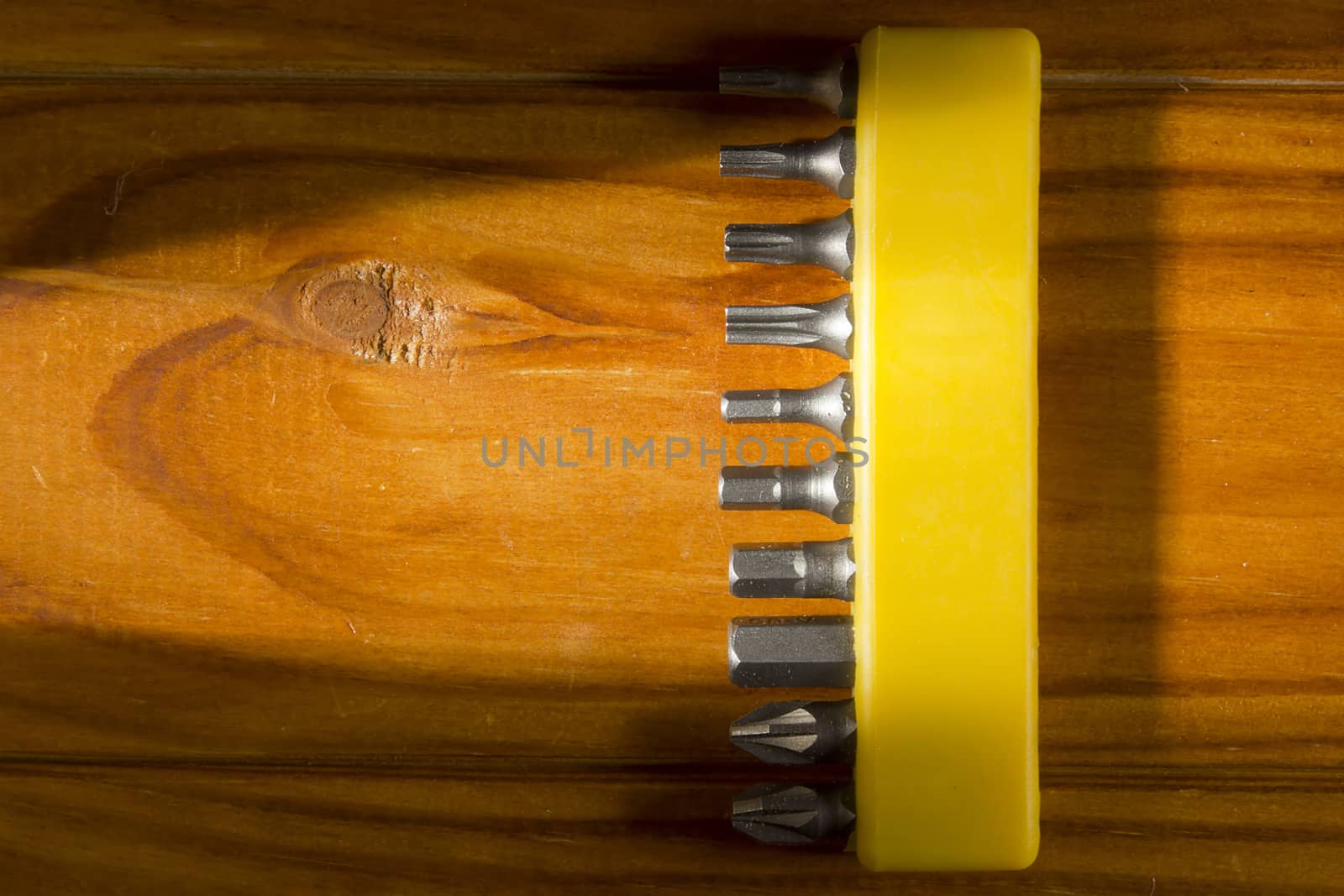 Set of screwdriver bits on a wooden background