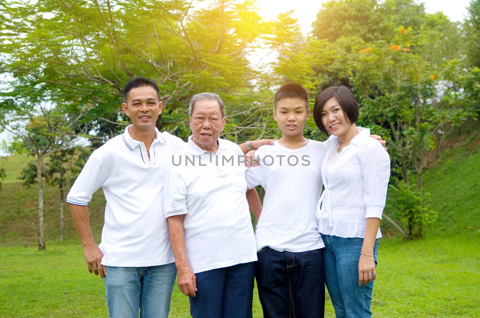 Portrait Of Multi-Generation Chinese Family Relaxing In Park Together