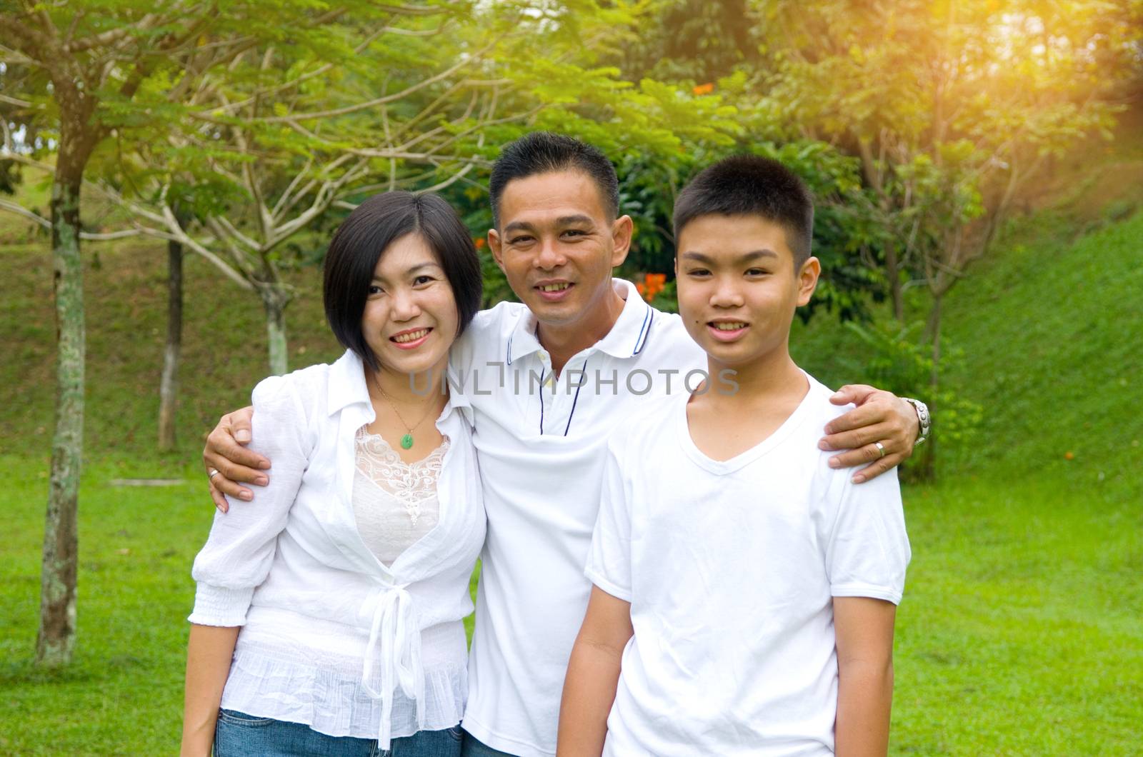 Chinese Family Relaxing In Park Together