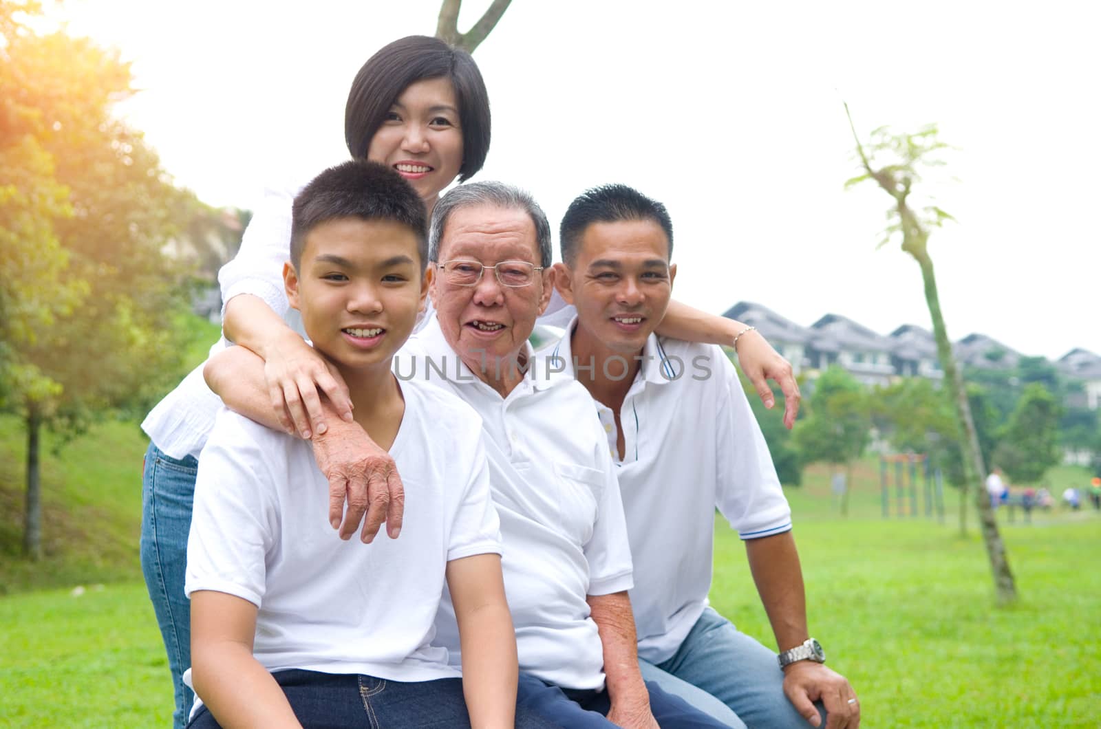 Portrait Of Multi-Generation Chinese Family Relaxing In Park 