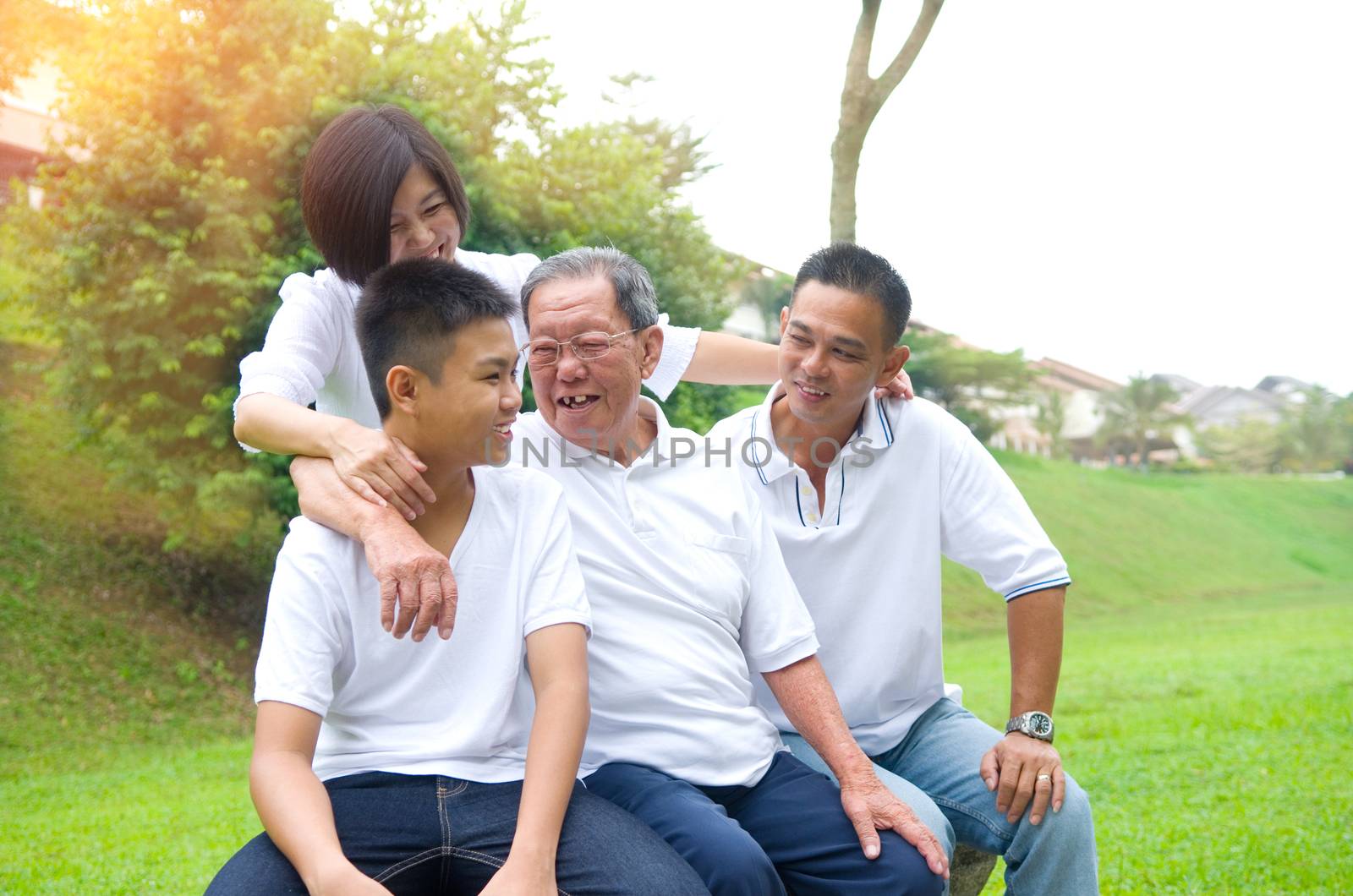 Portrait Of Multi-Generation Chinese Family Relaxing In Park 