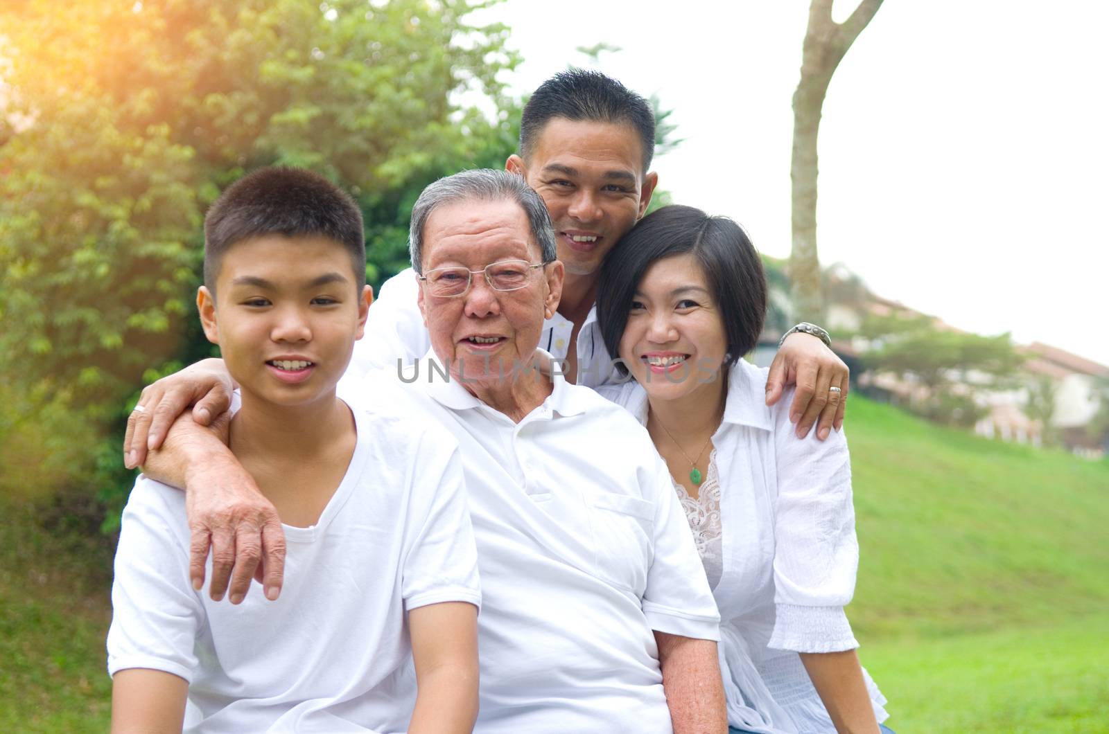 Portrait Of Multi-Generation Chinese Family Relaxing In Park 