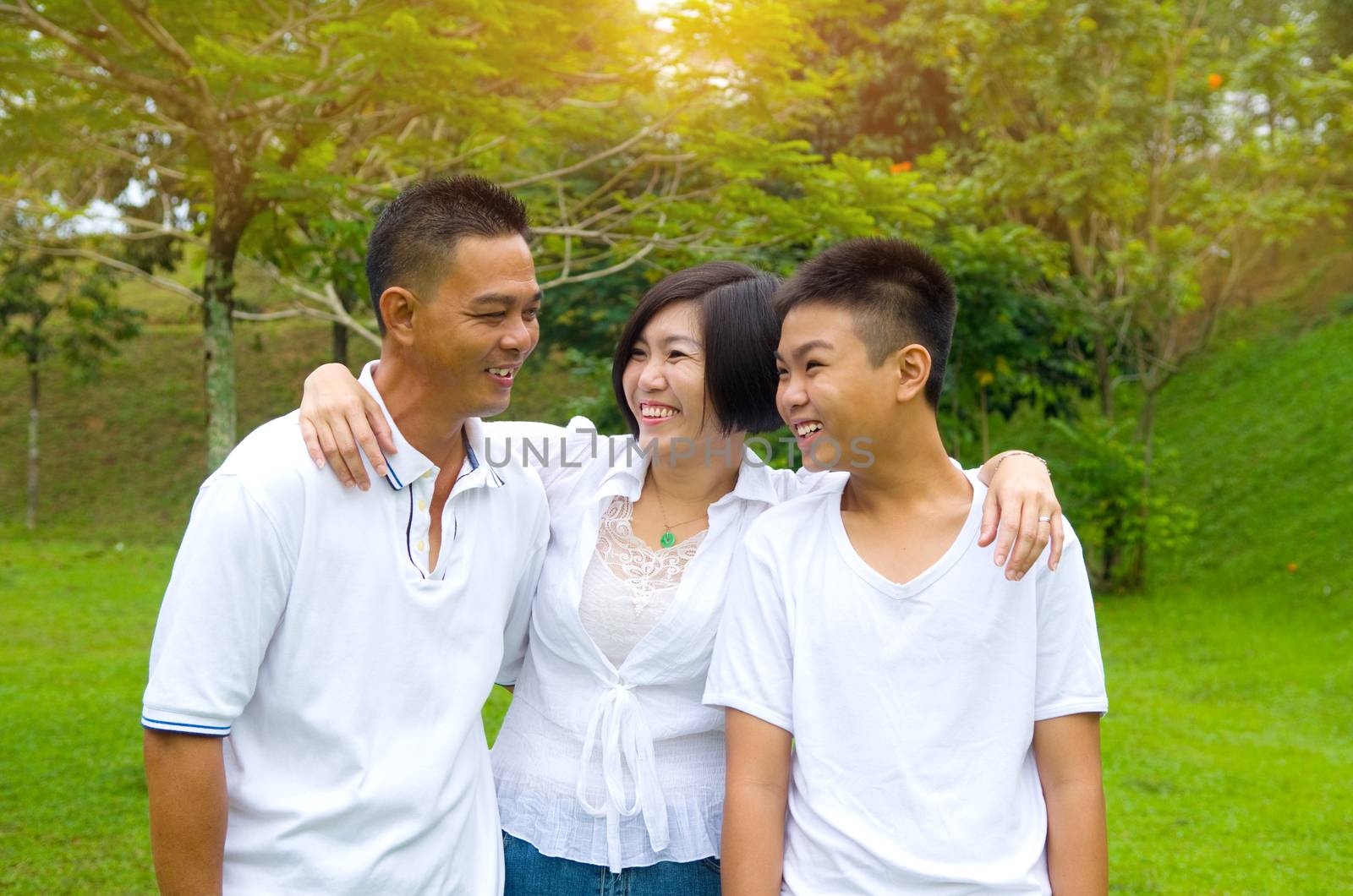 Chinese Family Relaxing In Park Together