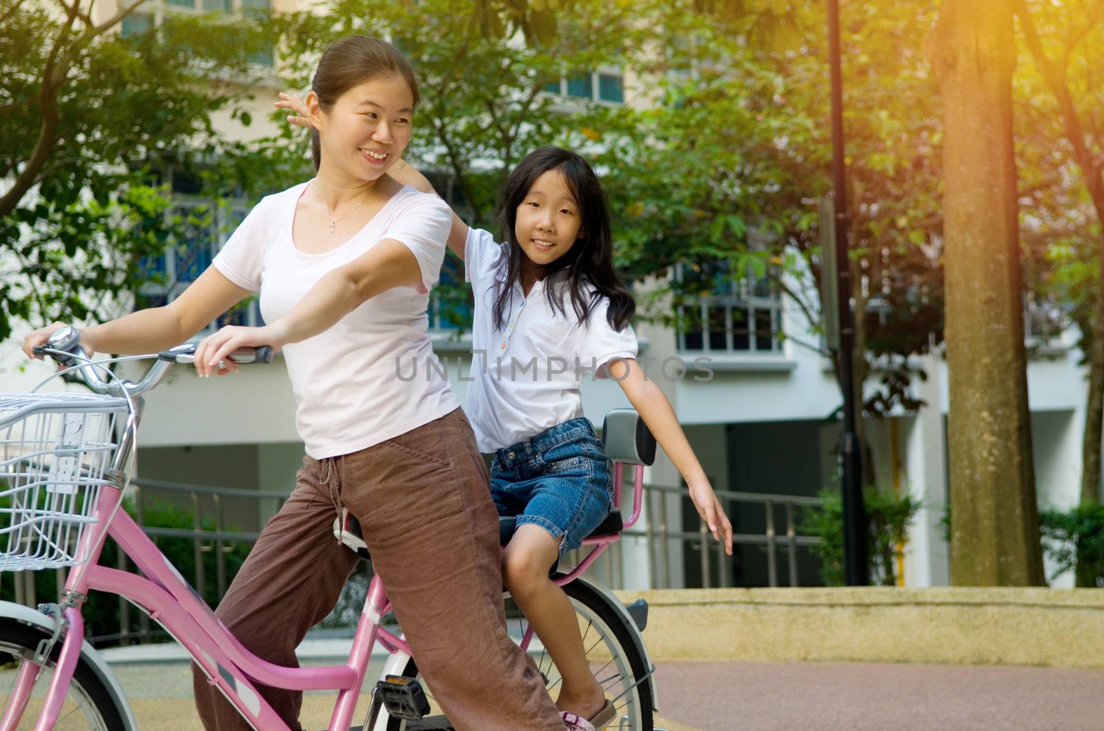 Mother and a daughter cycling bicycle at the park