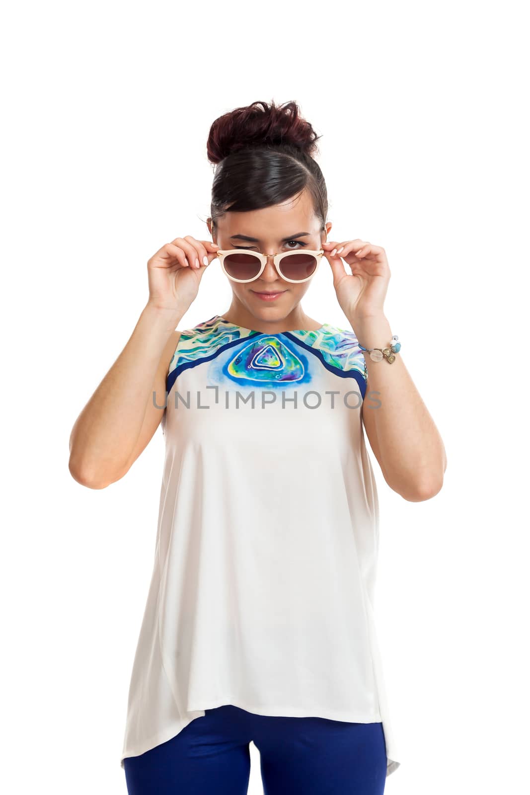 the young woman in sunglasses and in convenient clothes on a white background