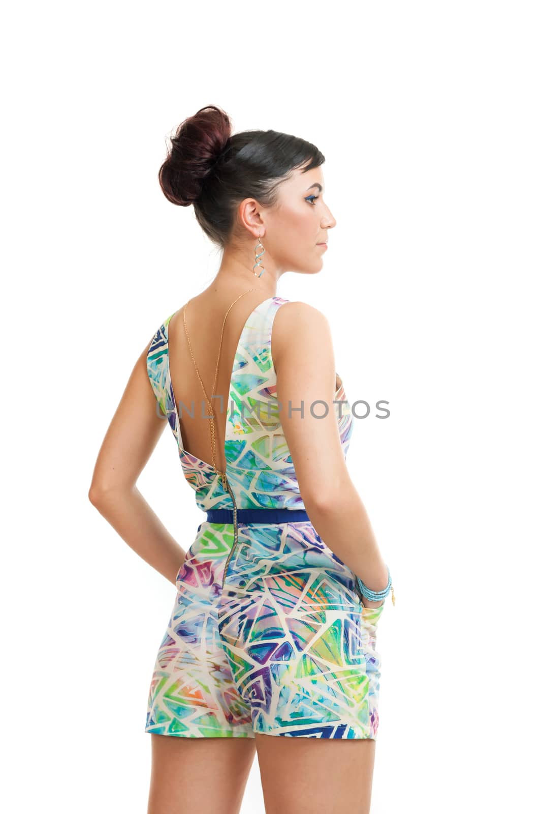 the young woman in convenient clothes a view from a back on a white background