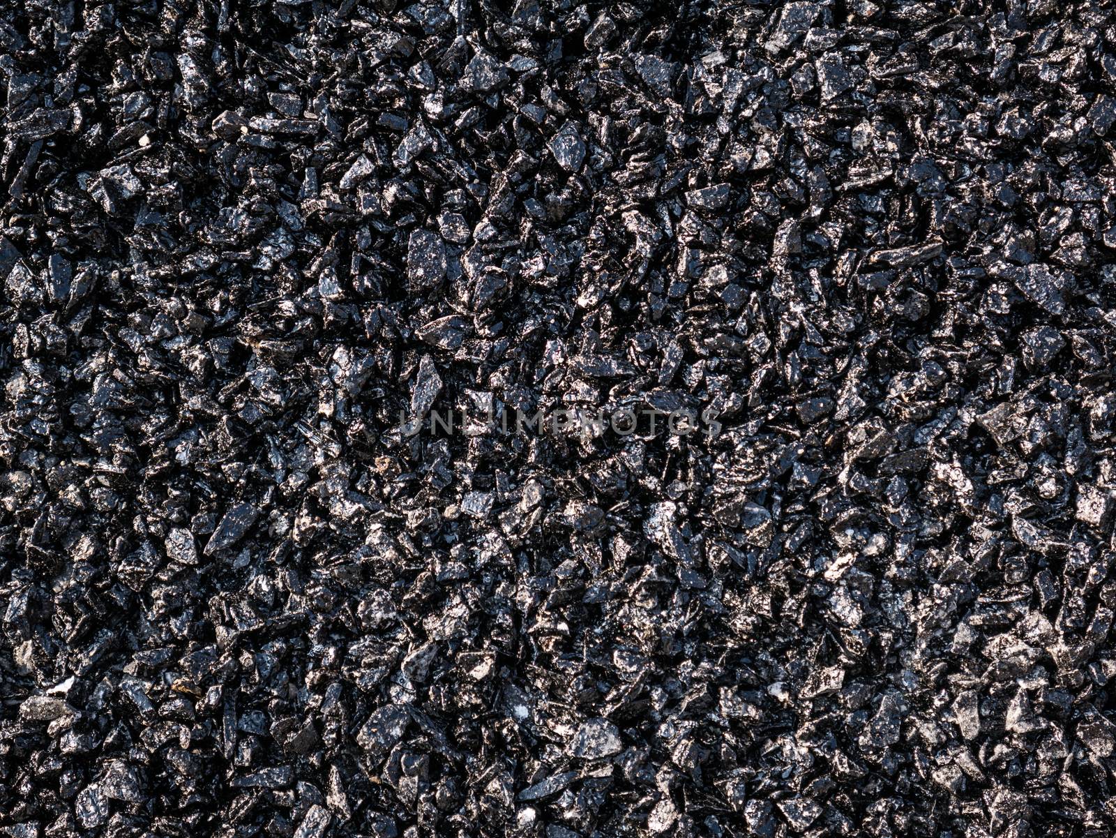 Close up asphalt road repair. Repair pavement and laying new asphalt patching method outdoors.