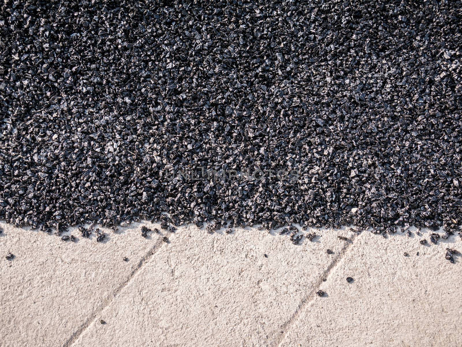 Close up asphalt road repair. Repair pavement and laying new asphalt patching method outdoors.