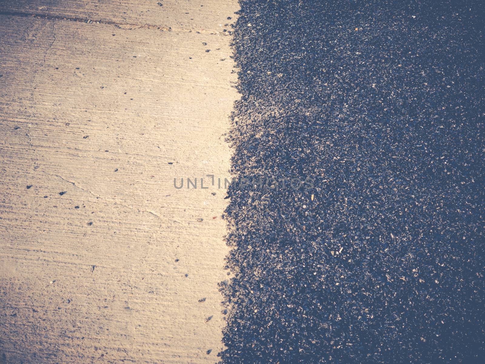Close up asphalt road repair. Repair pavement and laying new asphalt patching method outdoors.