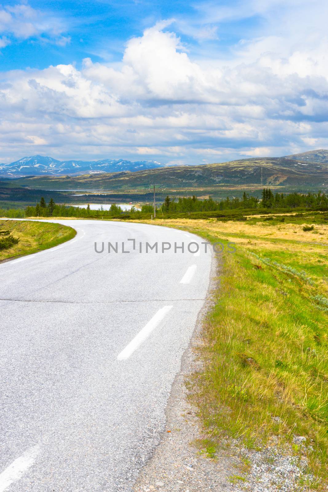 Road in Norway. Summer landscape with blue sky and mountains