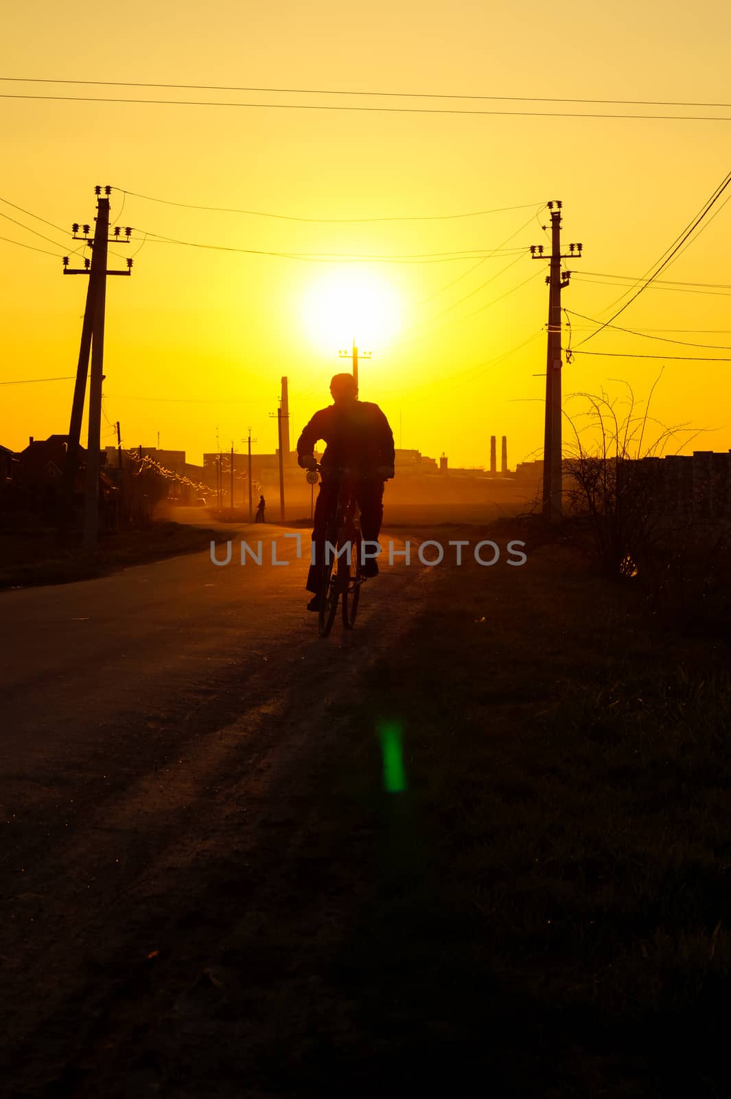 man on bike goes on the road during the sunset by Oleczka11