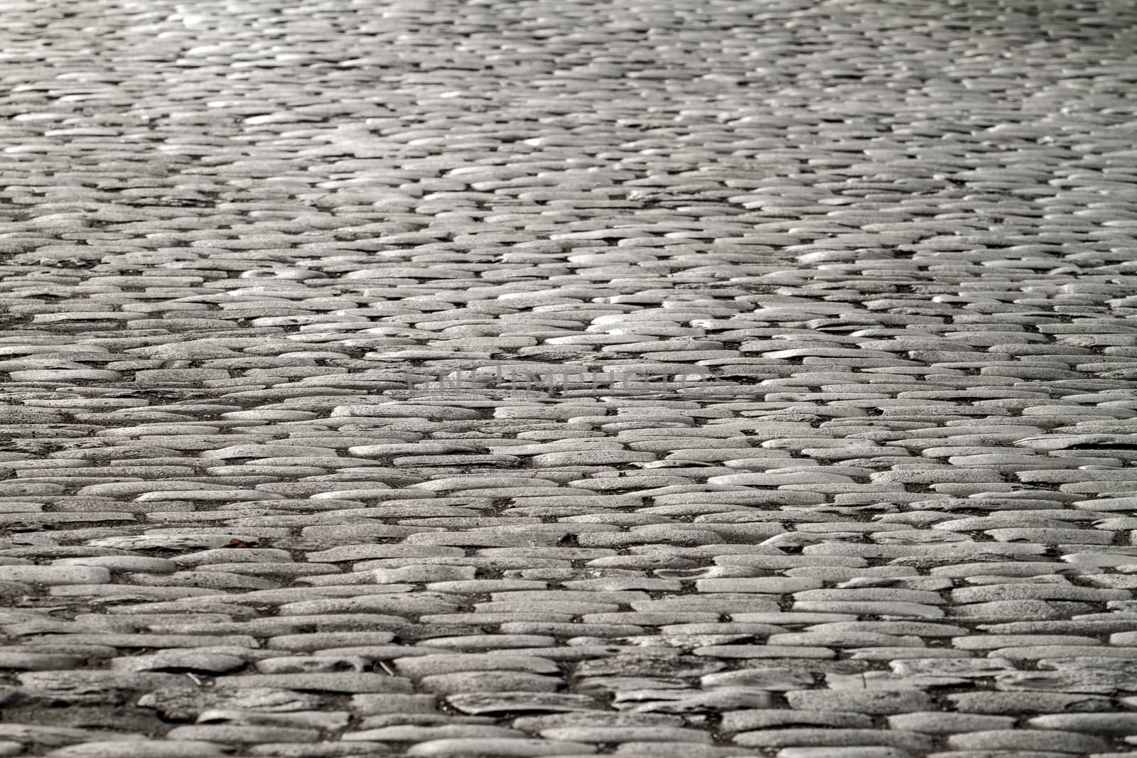 Old paving stones illuminated by moonlight. Abstract background.