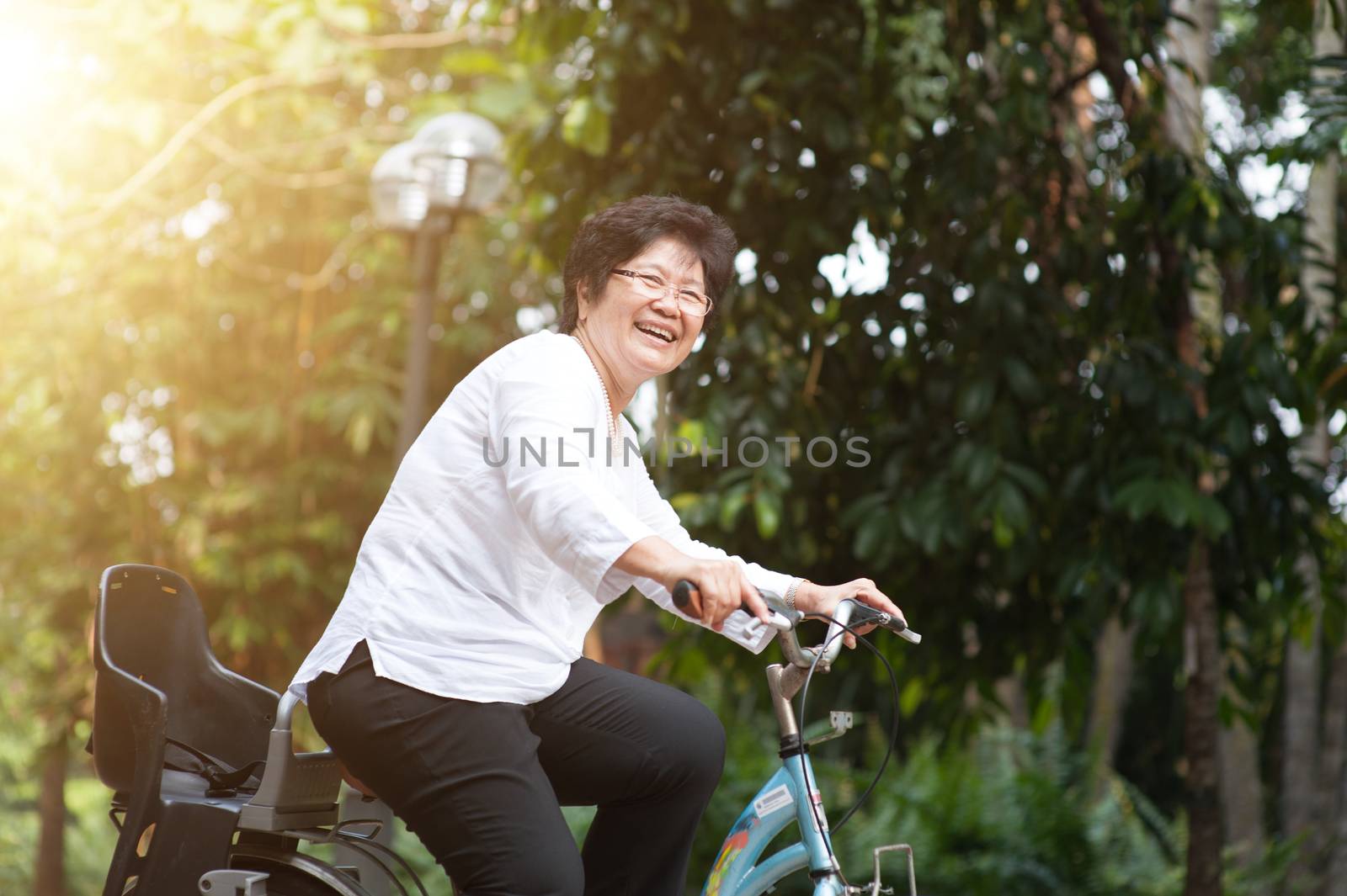 Elderly Asian woman biking by szefei