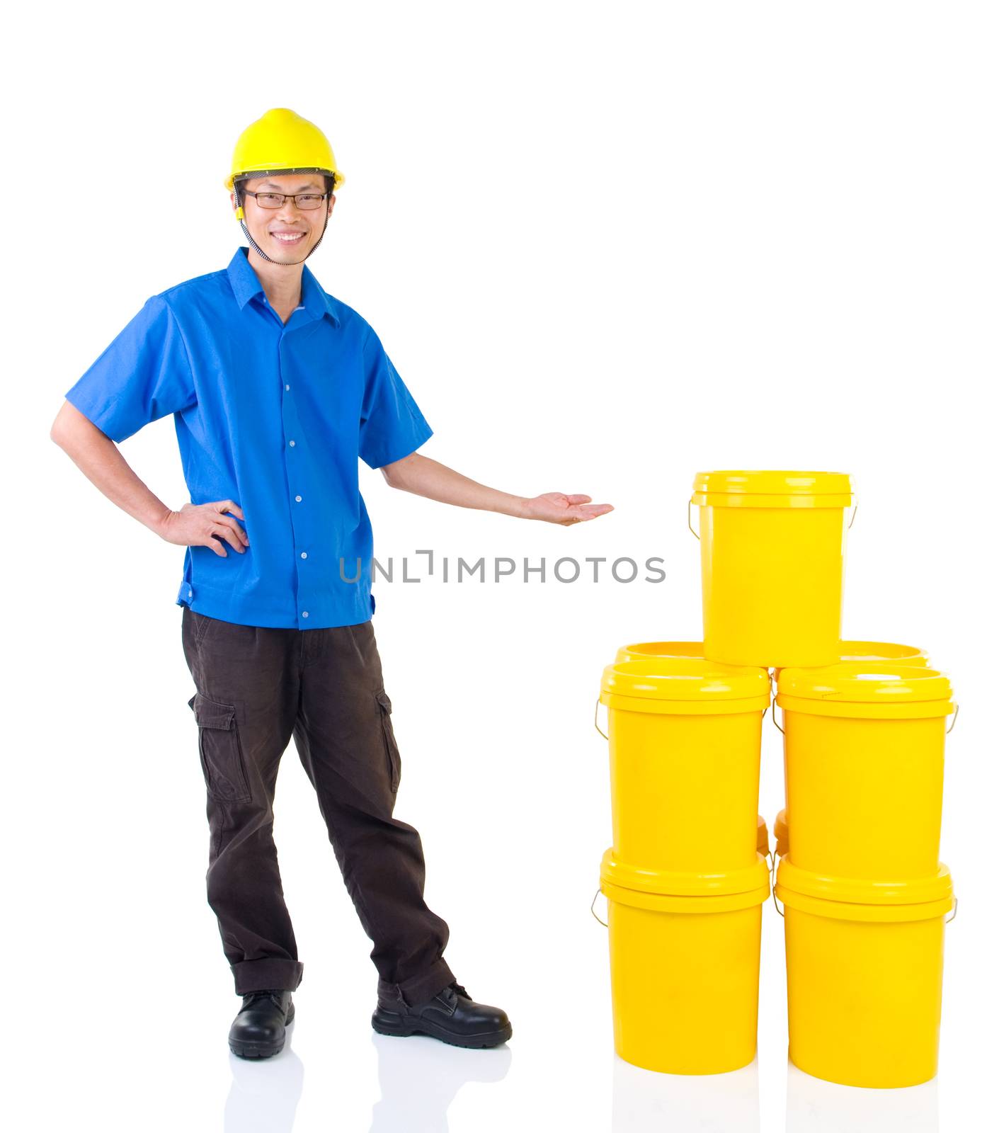 Lubricant oils and greases distributor with suit hardhat pointing his hand over the products , thumb-up, isolated on white background.