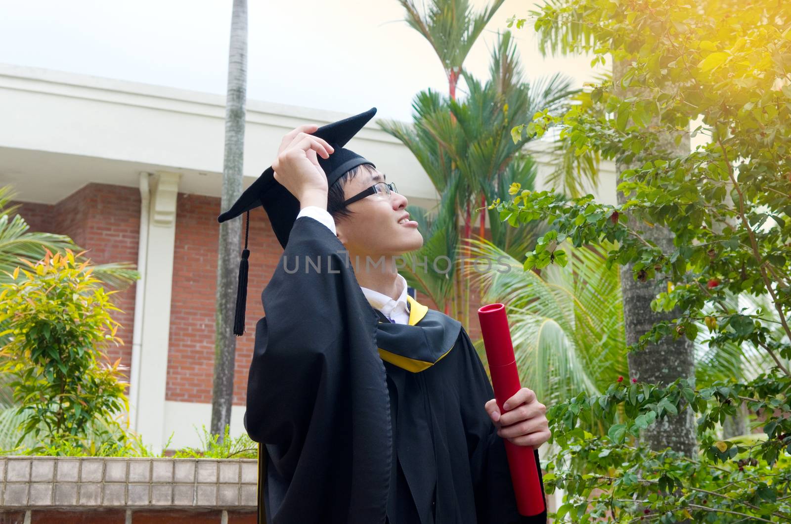 Cheerful asian university graduate