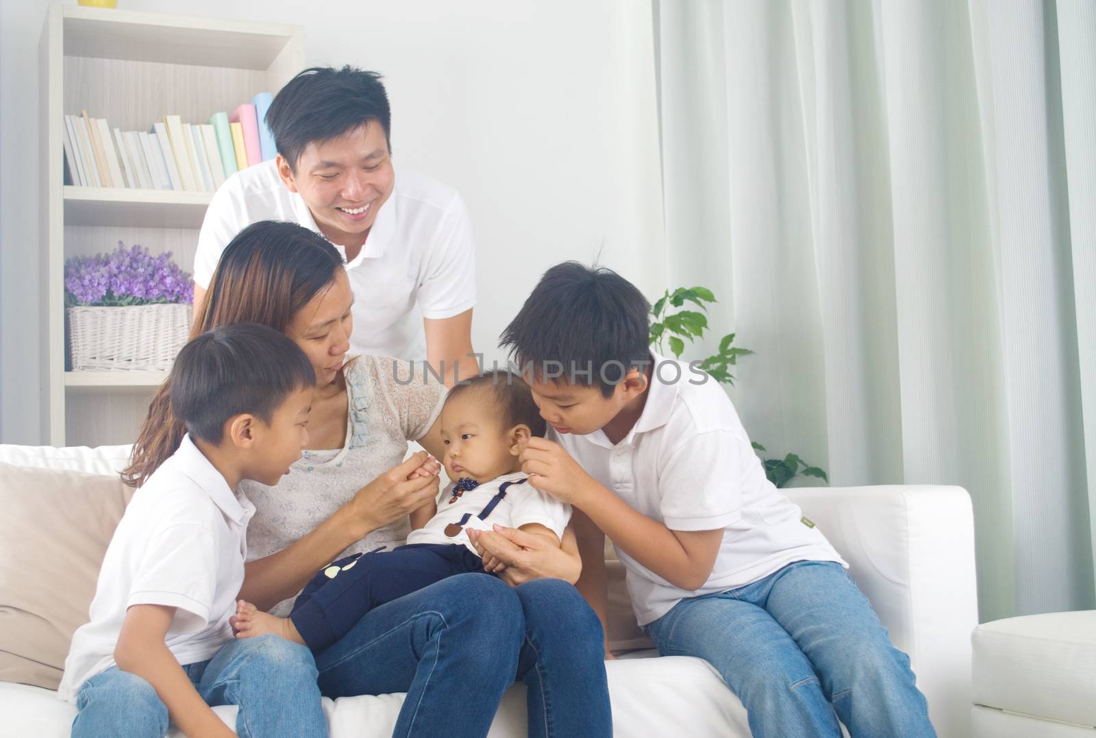 Asian family playing with baby