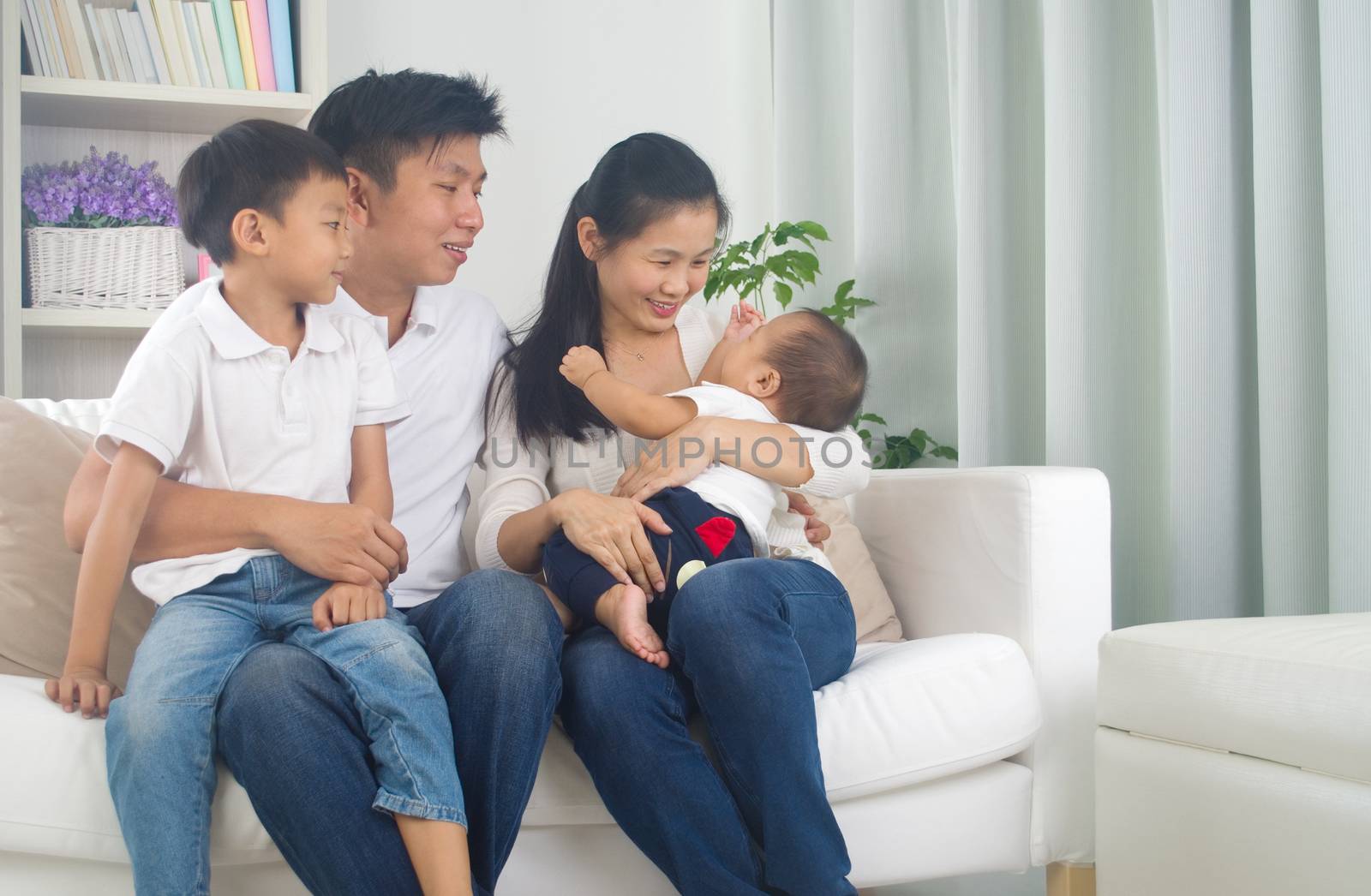 Asian family playing with baby