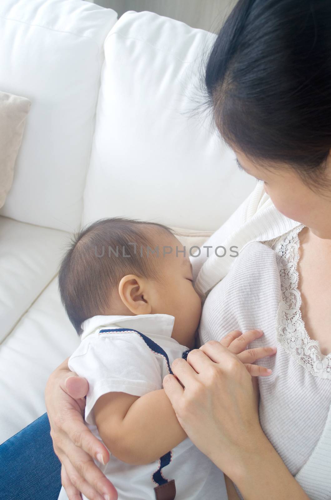 Asian mother breastfeeding her baby boy