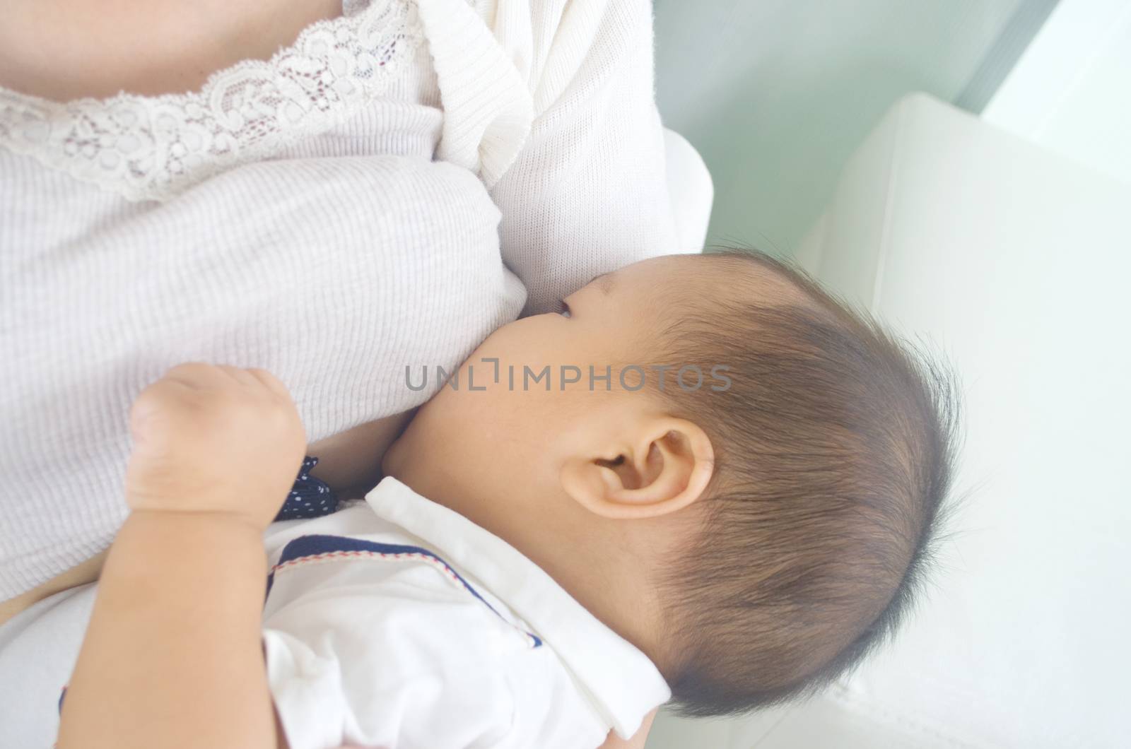 Asian mother breastfeeding her baby boy