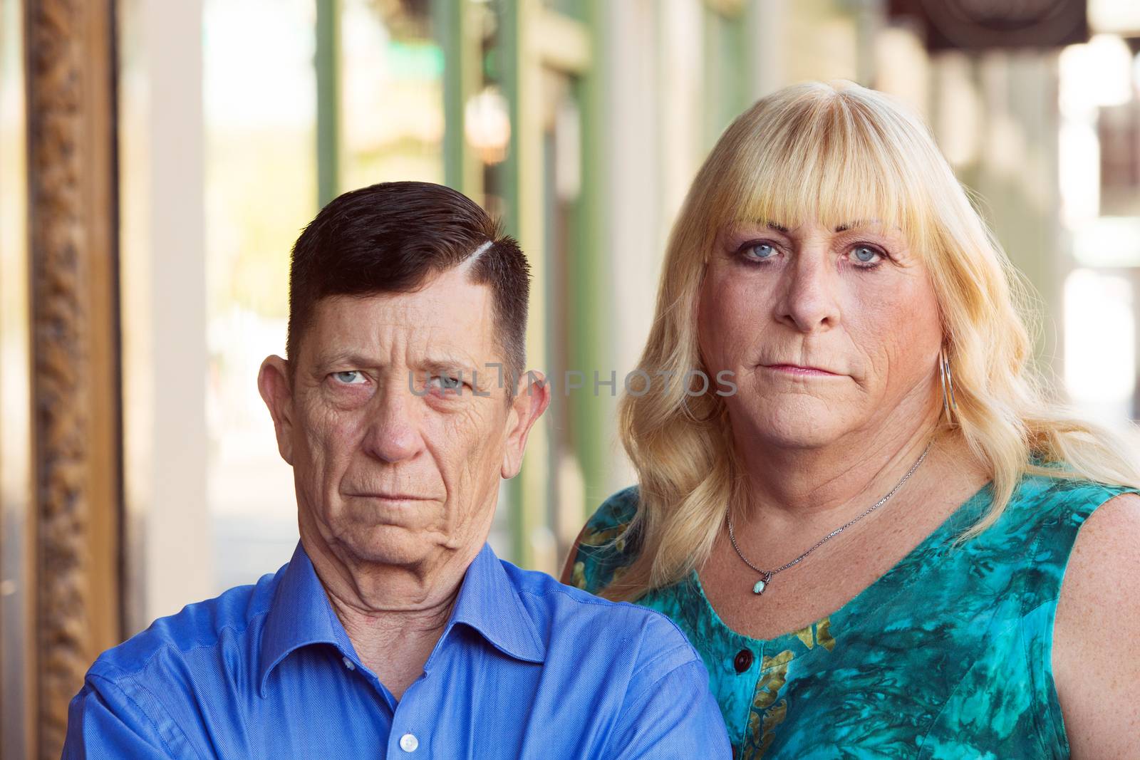 Serious transgender couple standing together by Creatista