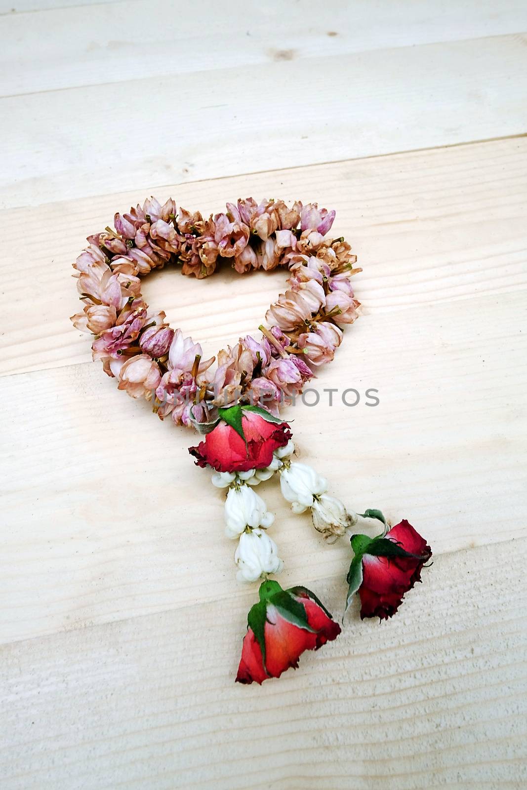 Dry Jasmine and Rose Flower Wreath Thai on the Table Wooden by aonip