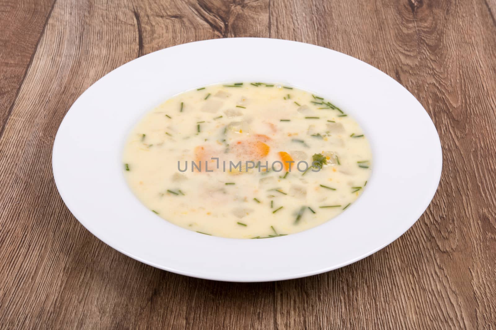 Vegetarian vegetable soup on a wooden table