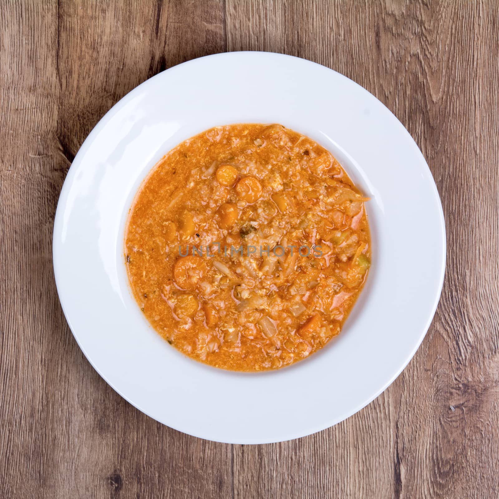 Vegetarian vegetable soup on a wooden table