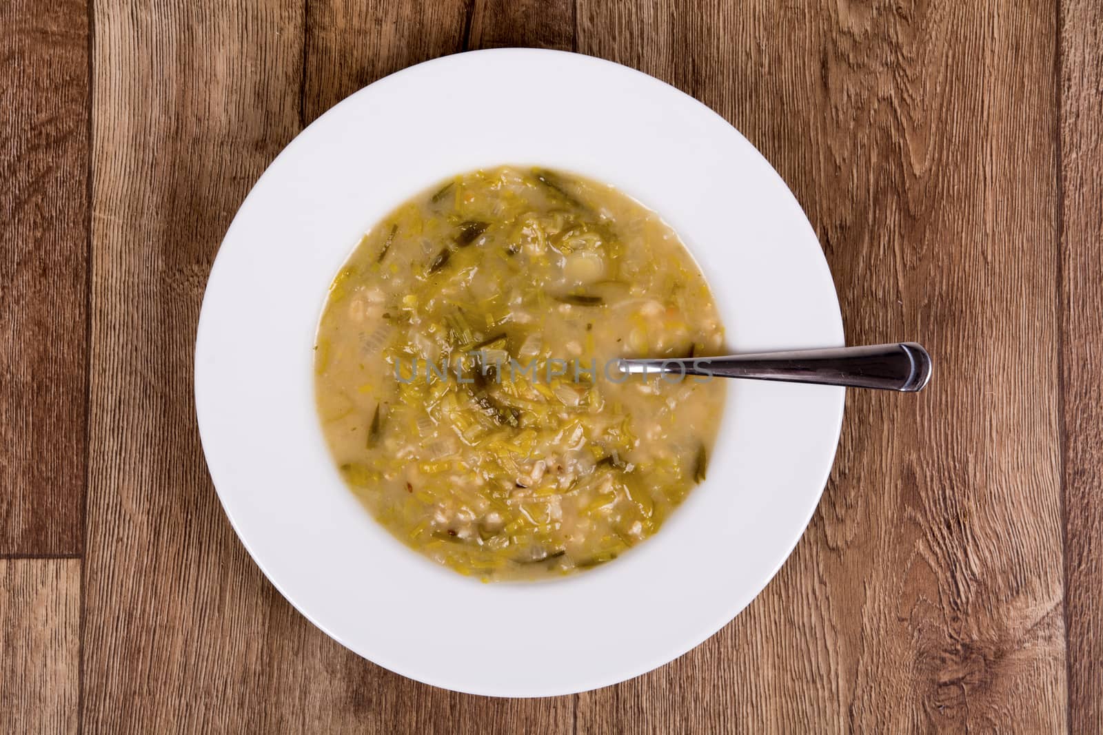 Vegetarian vegetable soup on a wooden table