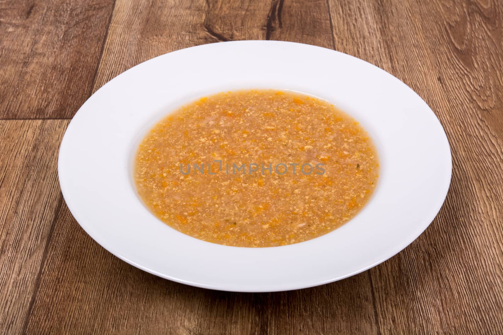 Vegetarian vegetable soup on a wooden table