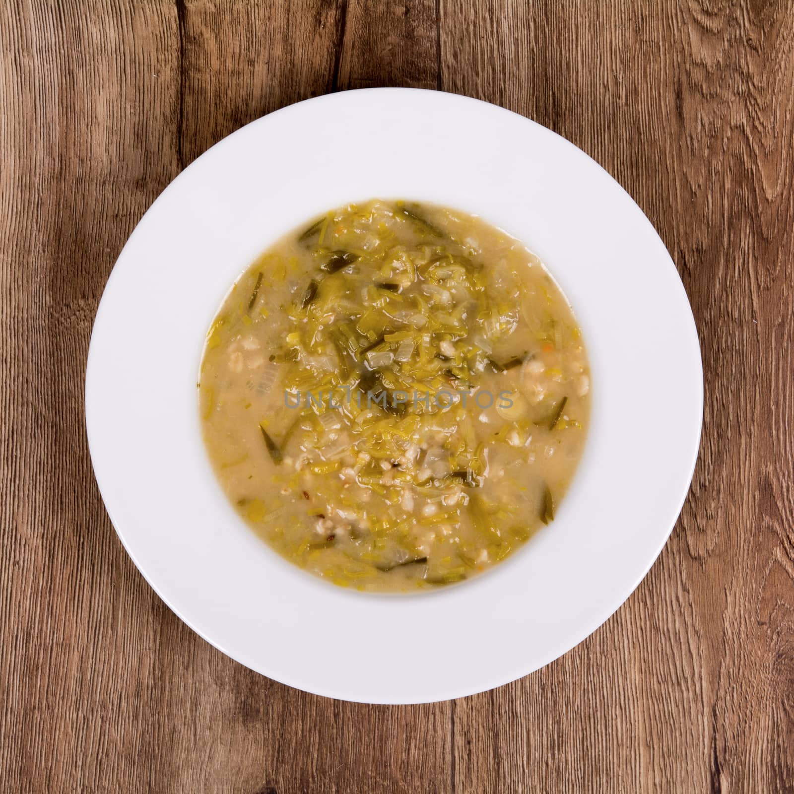 Vegetarian vegetable soup on a wooden table