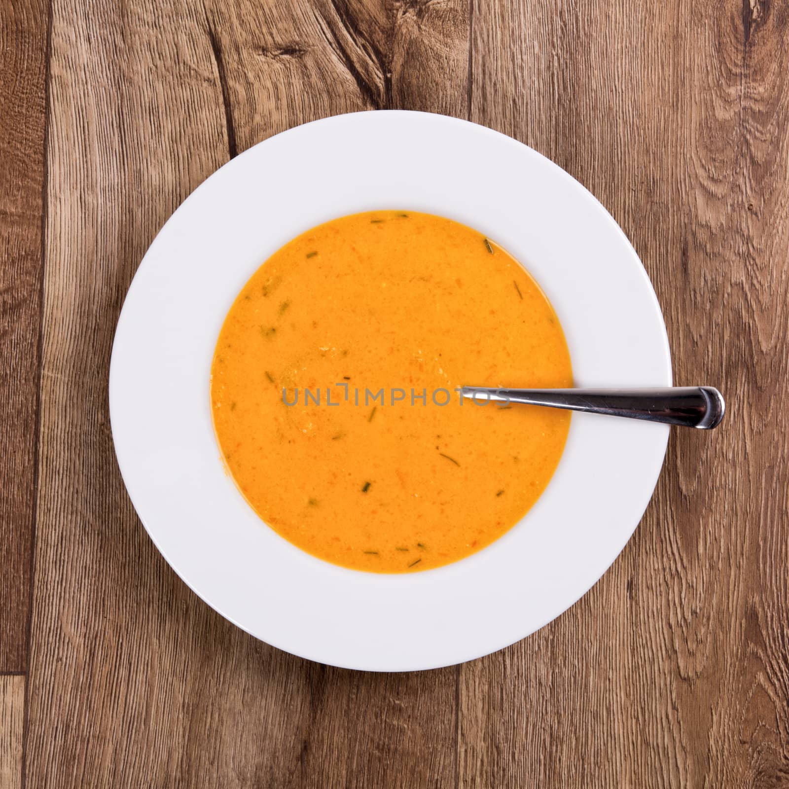 Vegetarian vegetable soup on a wooden table