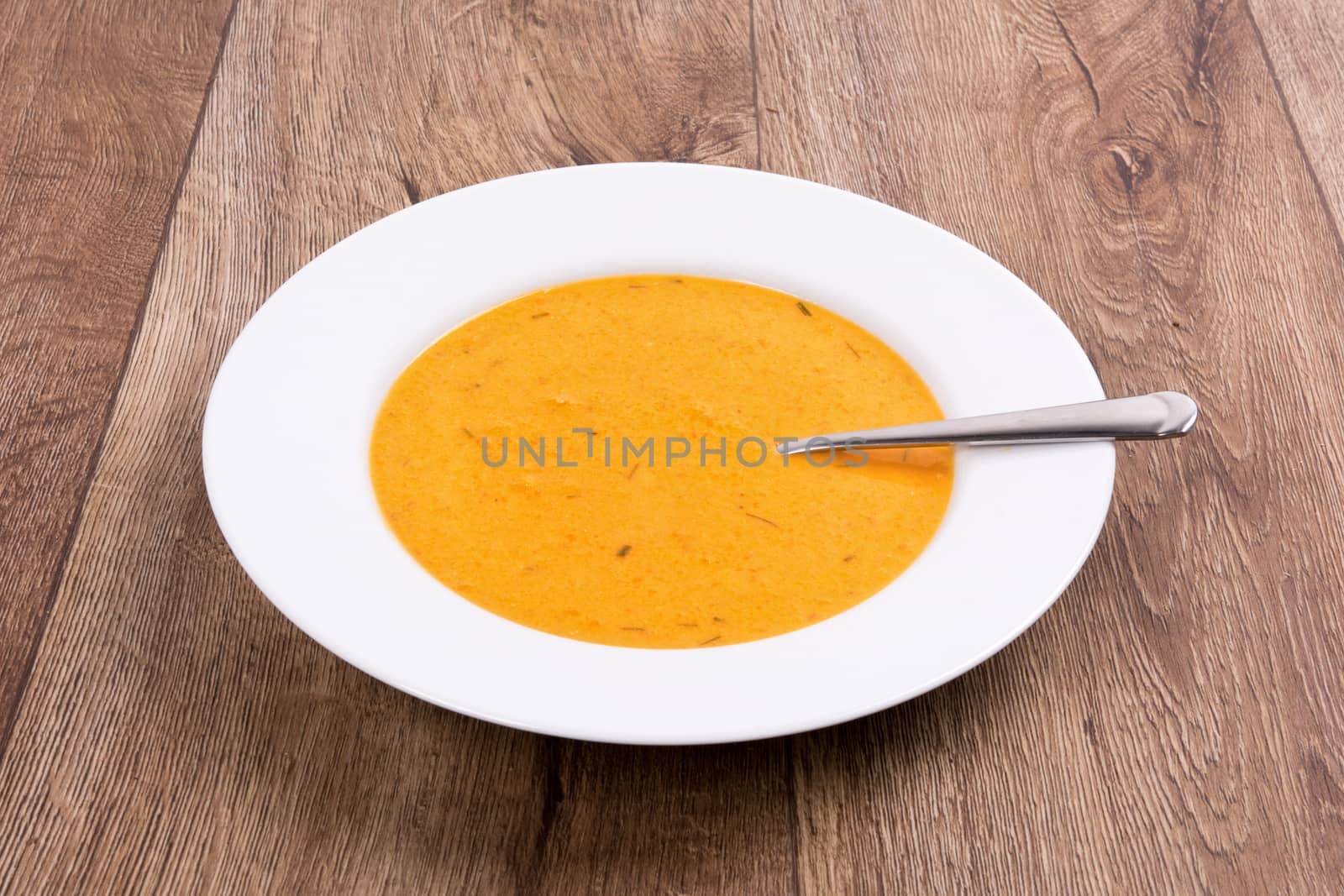 Vegetarian vegetable soup on a wooden table