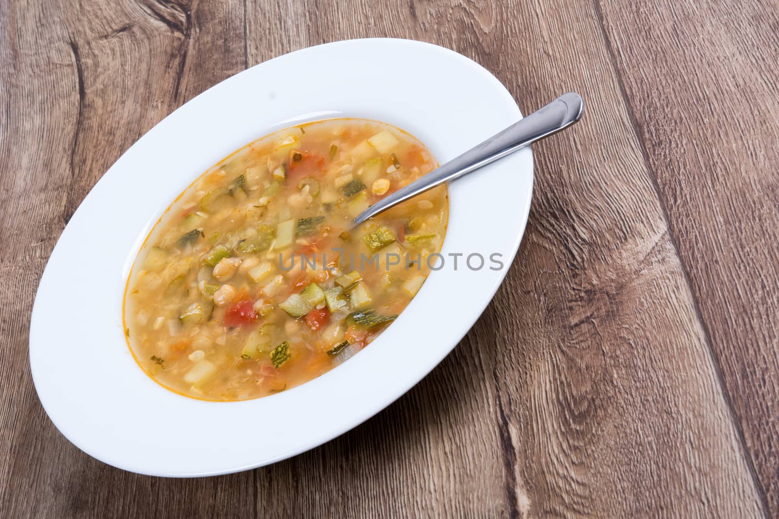 Vegetarian vegetable soup on a wooden table