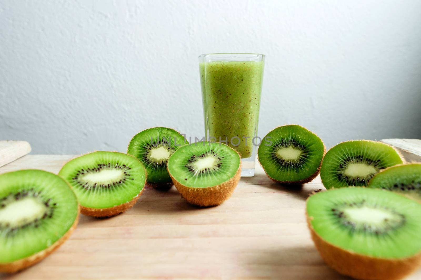 kiwi smoothie tropical fresh blended on wood table by avanti