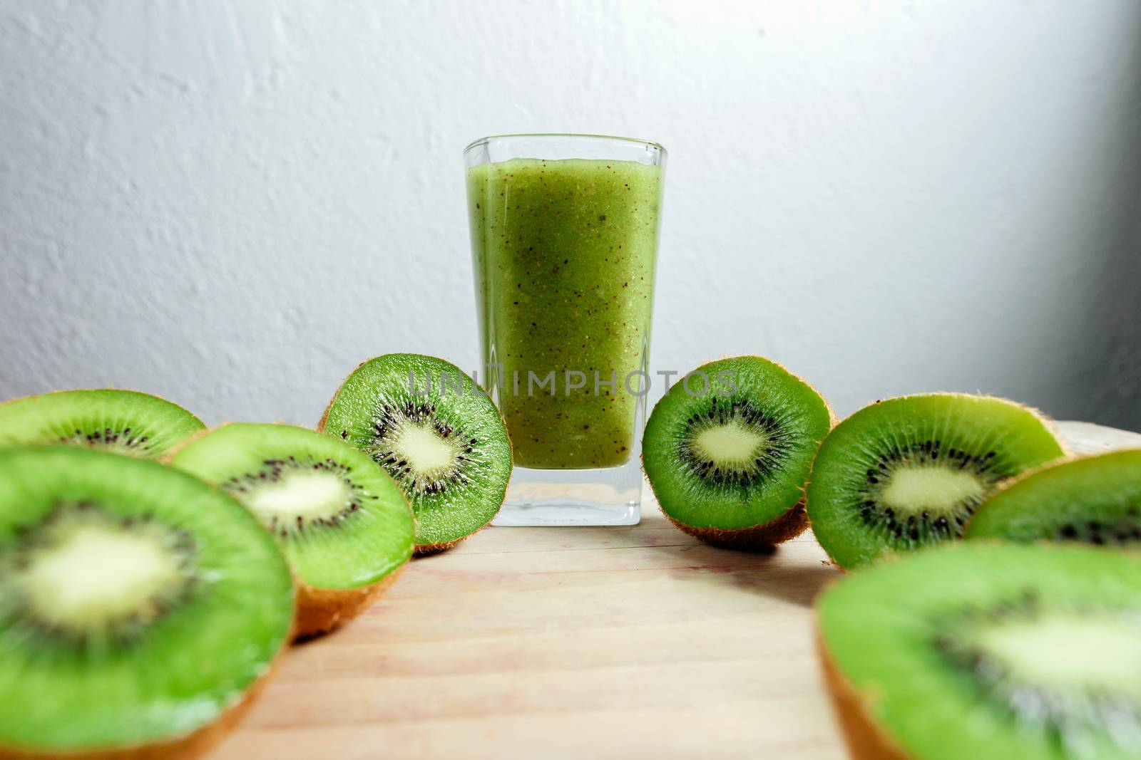 kiwi smoothie tropical fresh blended on wood table by avanti