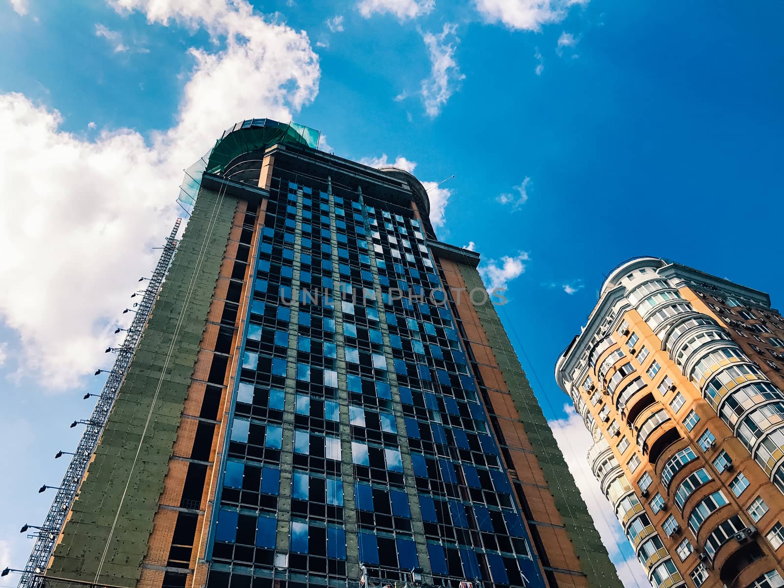 Top part of high-rise business building on blue sky 