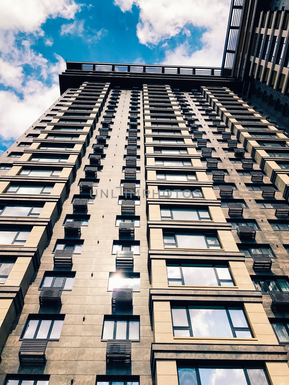 Top part of high-rise business building on blue sky 