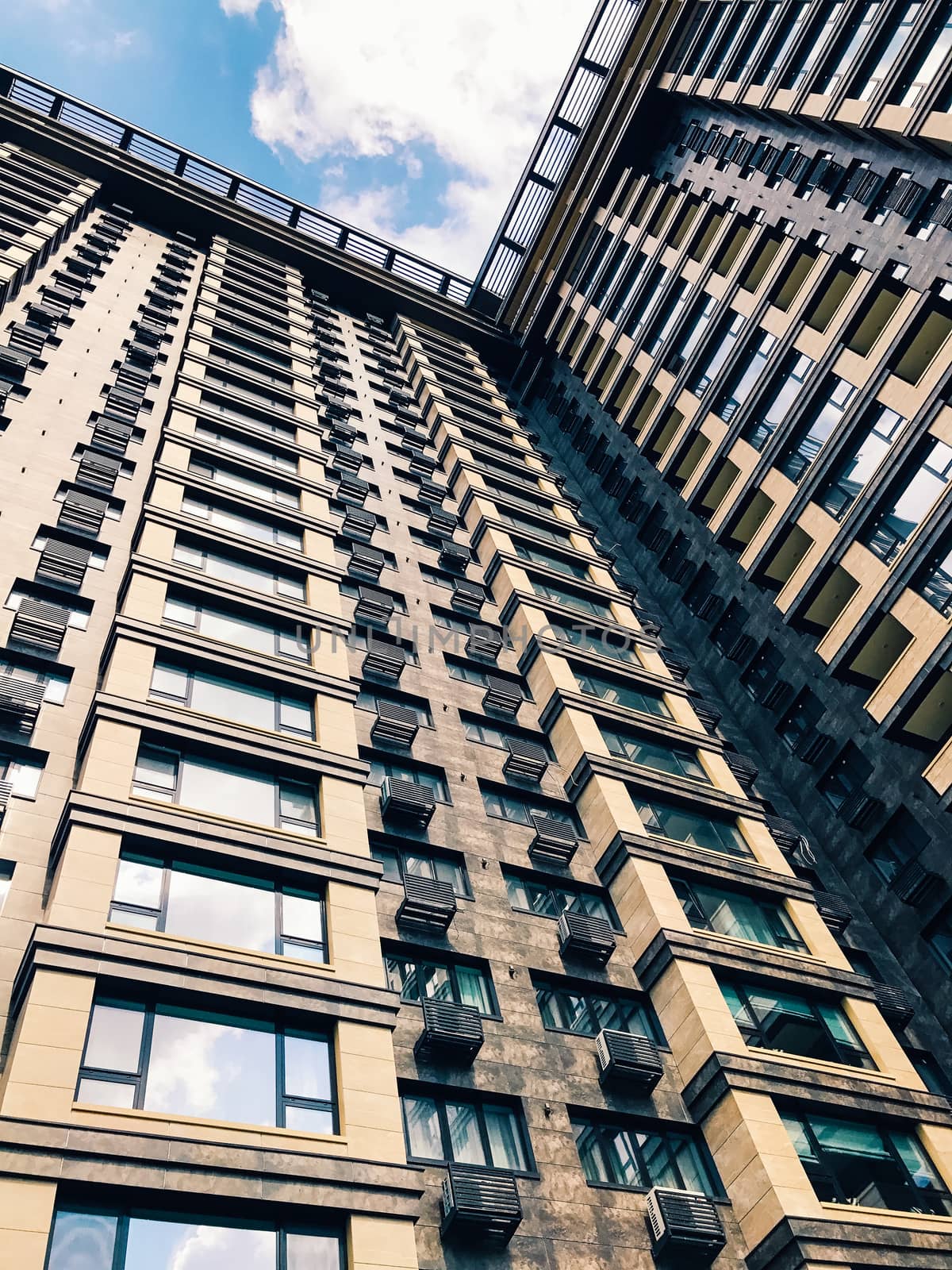 Top part of high-rise business building on blue sky 