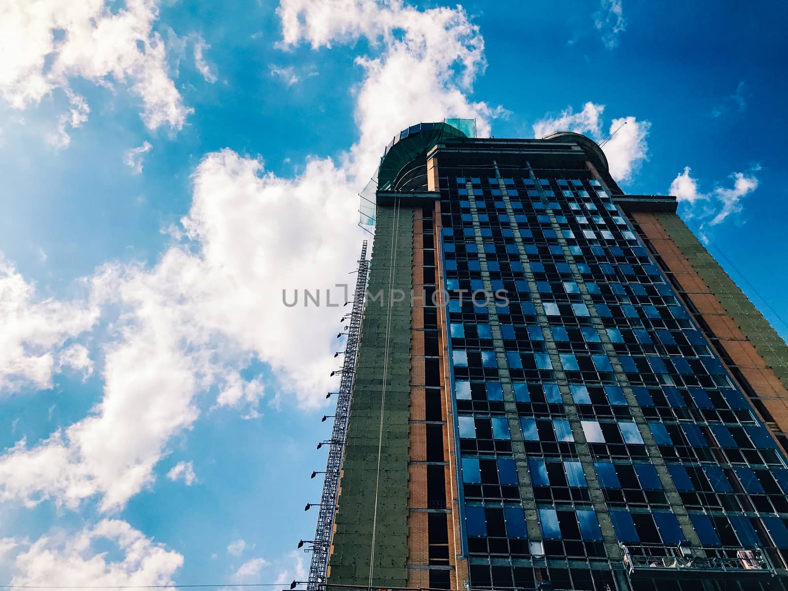 Top part of high-rise business building on blue sky 