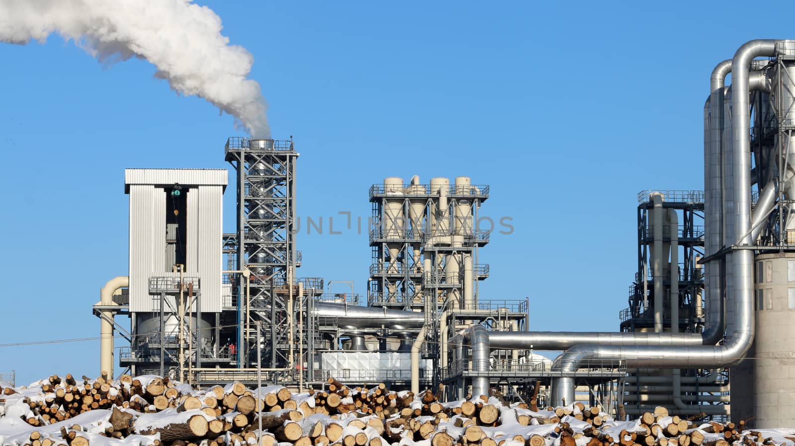 White smoke from the chimney on blue sky background. Ecology industry environment factory pollution