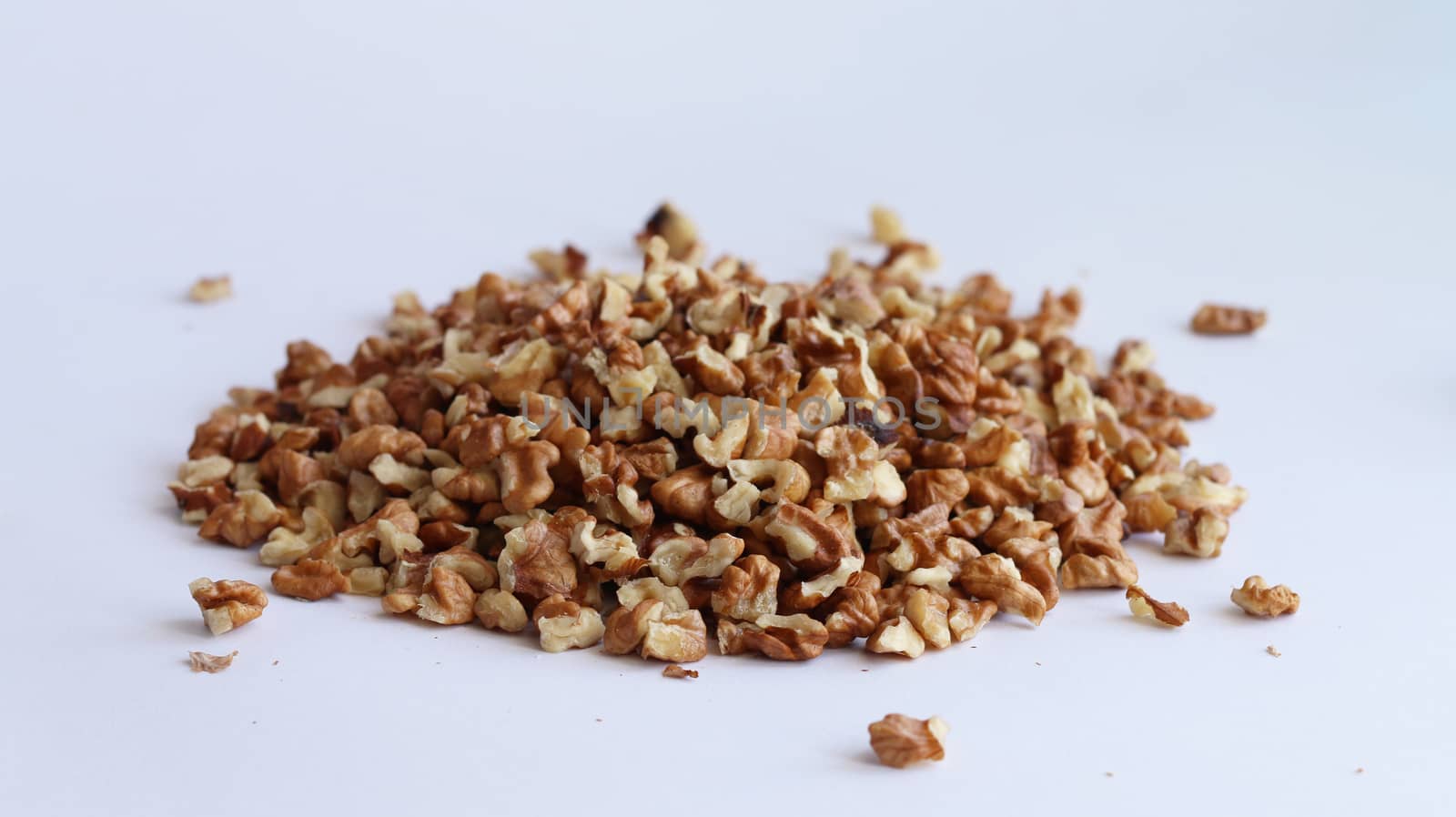 Spill purified walnut on white background, Drupe pile heap