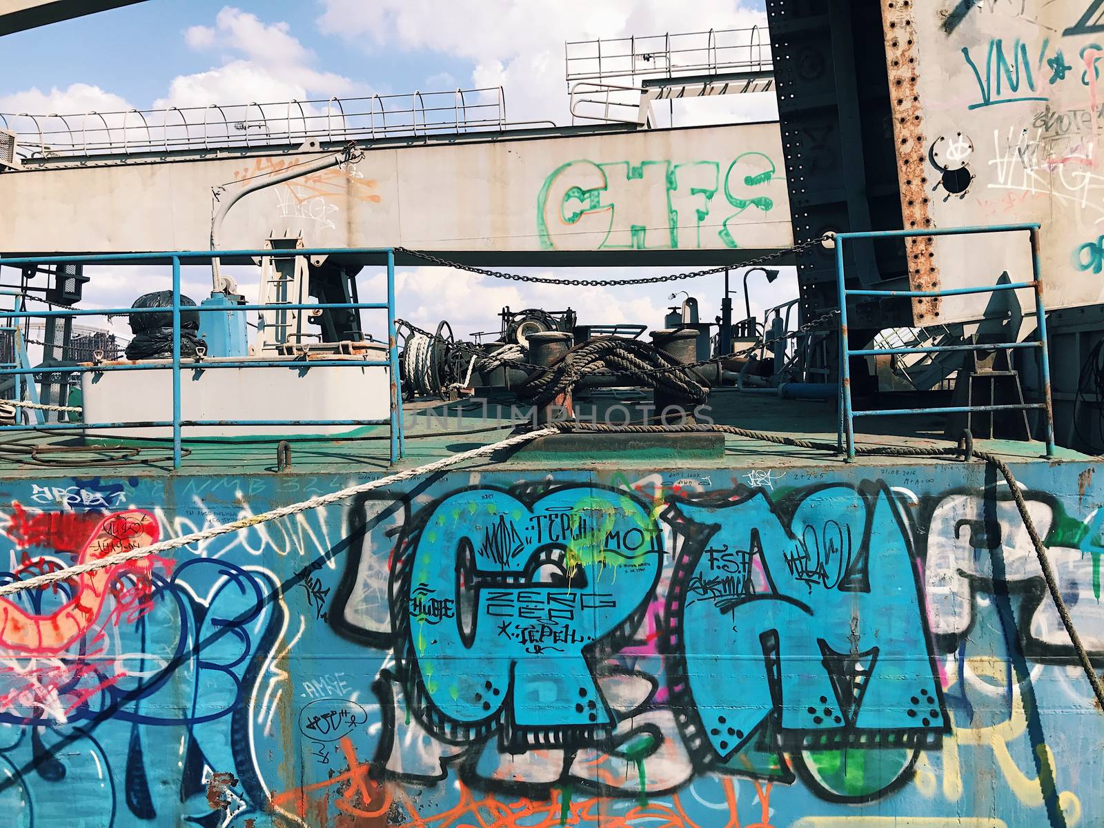 Graffiti background. Urban street art on abandoned ship ferry  port pier