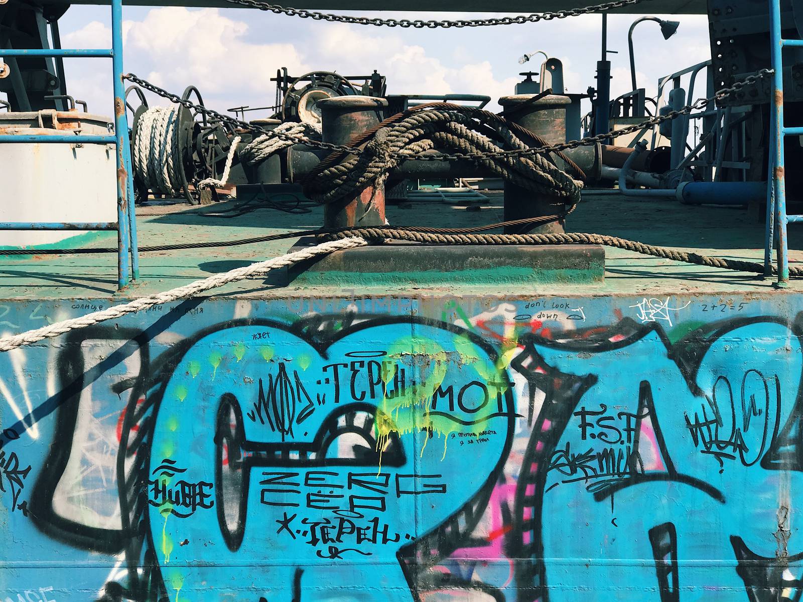 Graffiti background. Urban street art on abandoned ship ferry  port pier