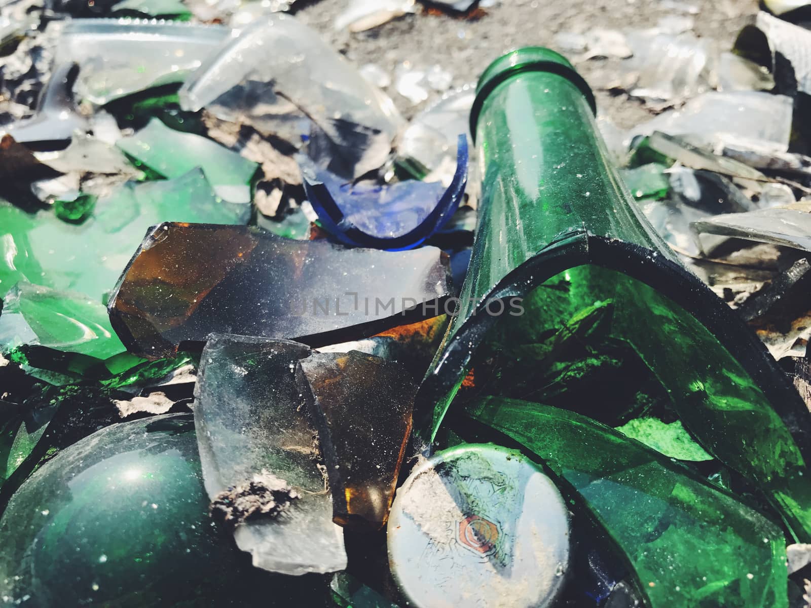 A lot of broken color bottle. Glass background by Softulka