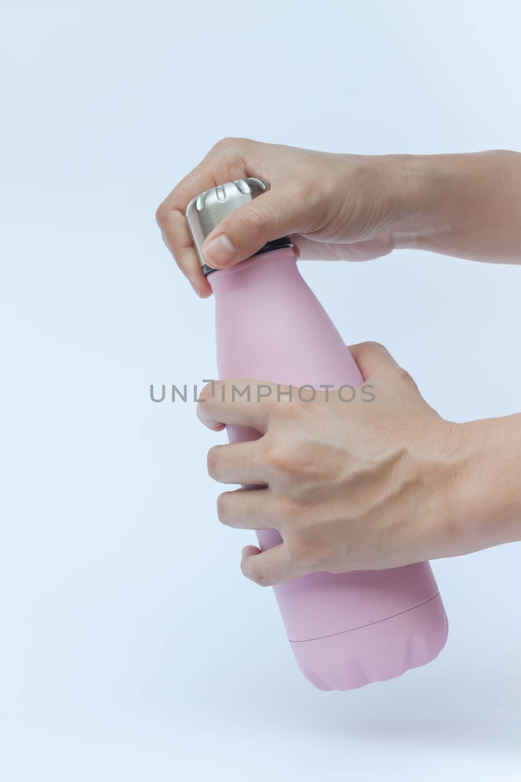 Woman hand holding warm bottle isolated on white background, stock photo