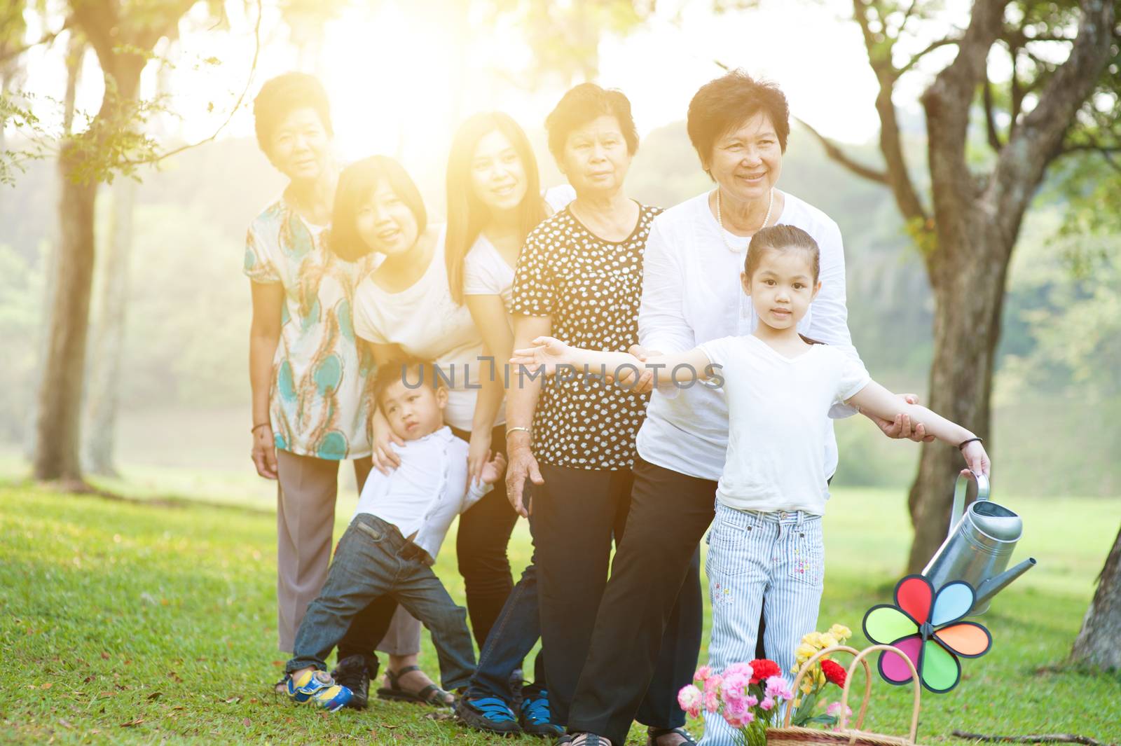 Big group of Asian multi generations family outdoors by szefei