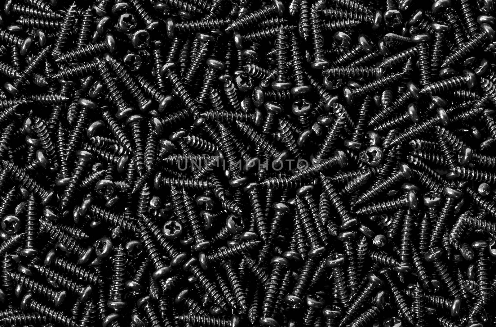Background pile of shiny black screws by Cipariss