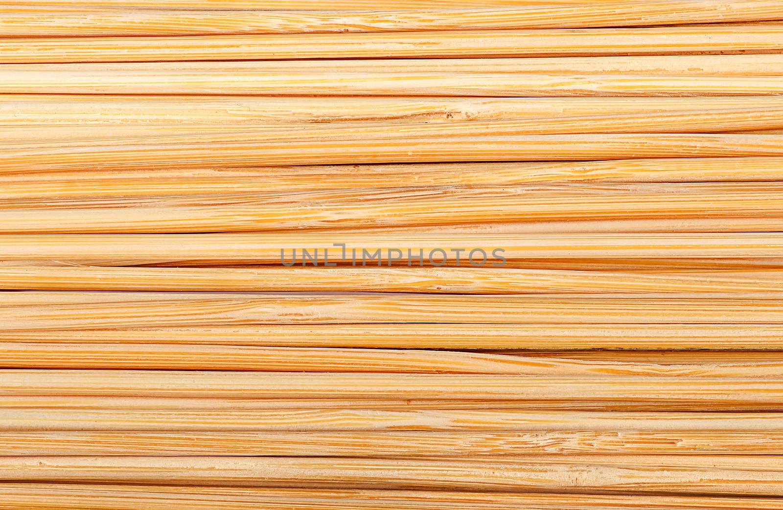 Closeup abstract background of bamboo sticks stacked next to each other