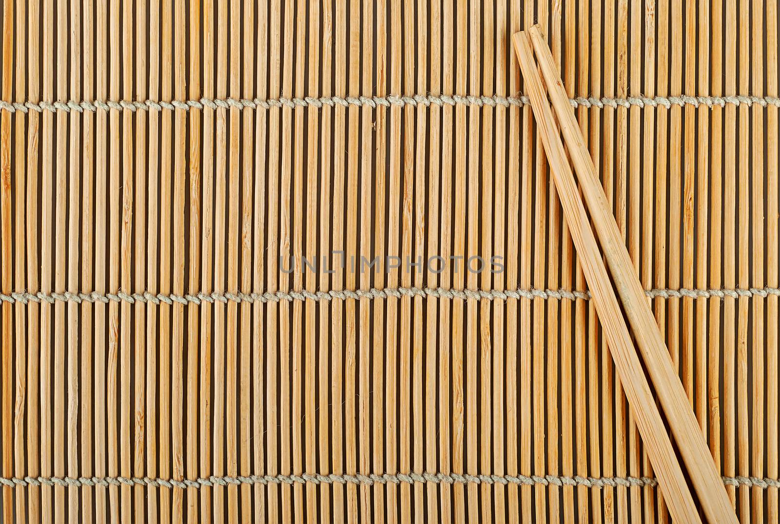 Abstract background bamboo sushi mat and chopsticks on top